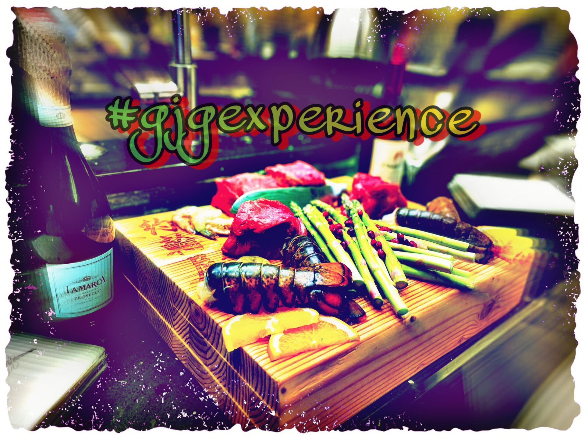 A picture of a cutting board with meat and asparagus and the words #rigexperience