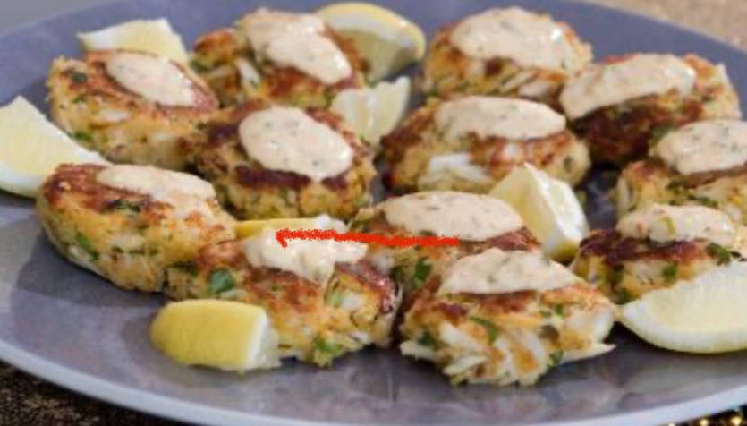 A plate of food with lemon slices and sauce on it