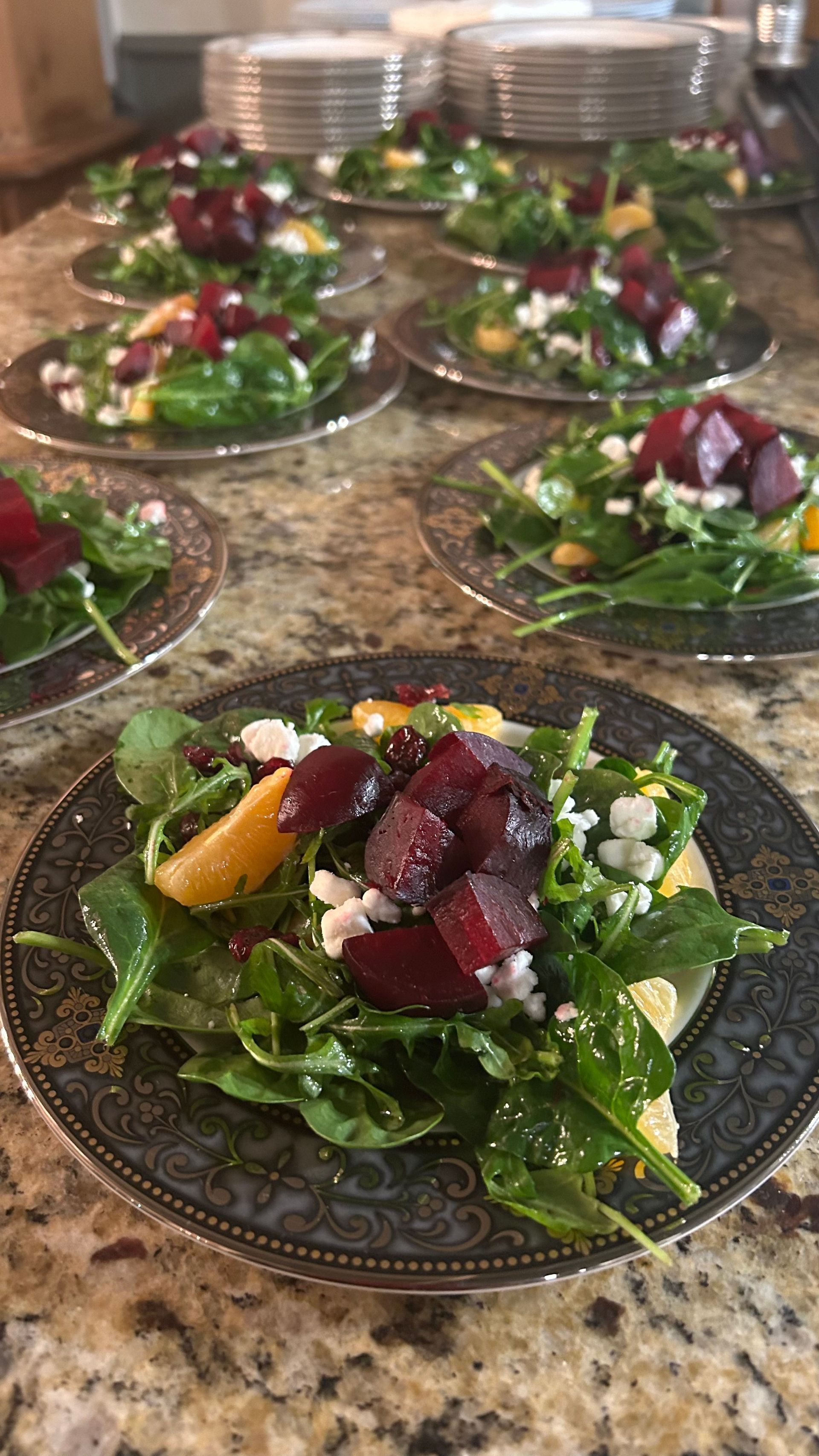 A close up of a salad on a plate on a table.