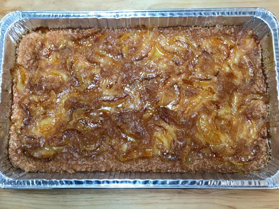 A casserole dish filled with a cake on a wooden table.