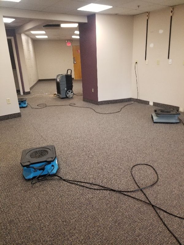 An empty room with a vacuum cleaner on the floor