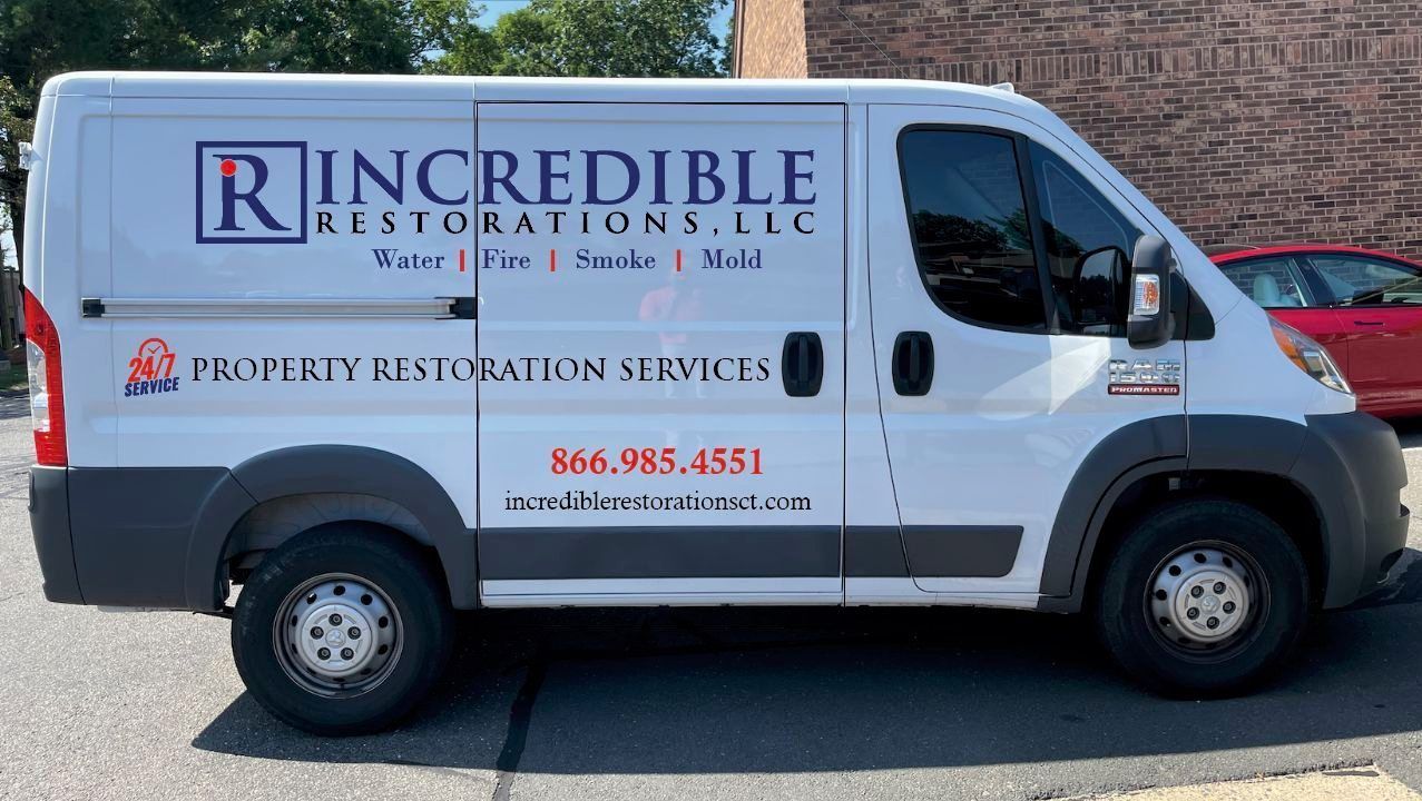 A white Incredible Restorations LLC work van parked outside.