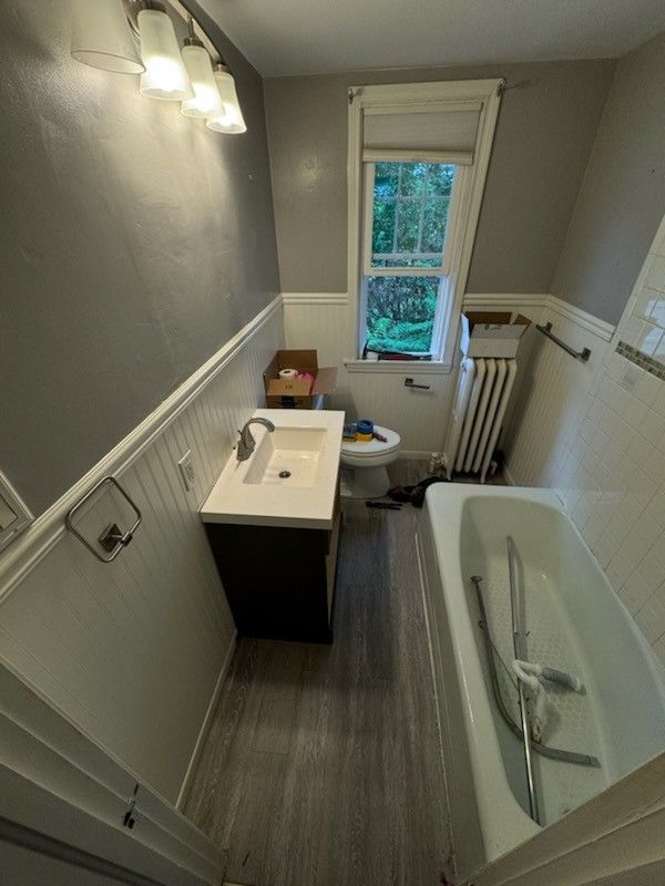 A bathroom with a sink , toilet , and bathtub