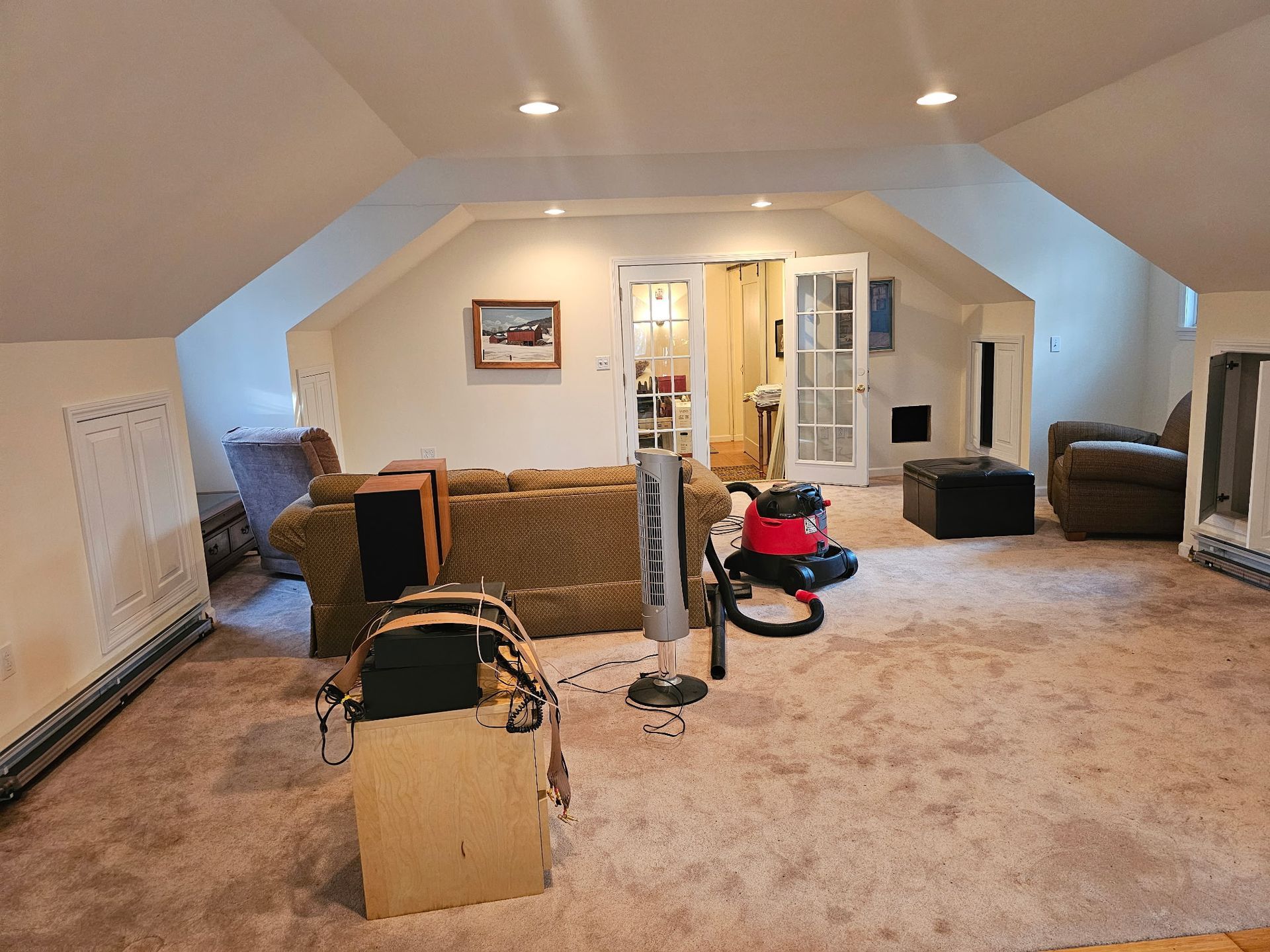 There is a vacuum cleaner in the middle of the room.