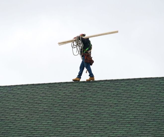 man walking on a roof seam