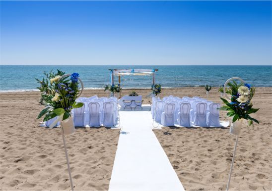 A blurred image of a beach with a city in the background.