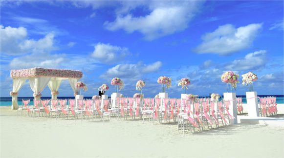 A blurred image of a beach with a city in the background.