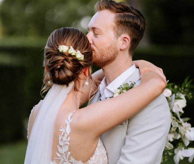 A bride and groom kissing on their wedding day