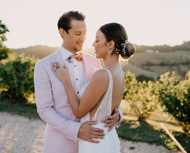 A bride and groom are posing for a picture on their wedding day.