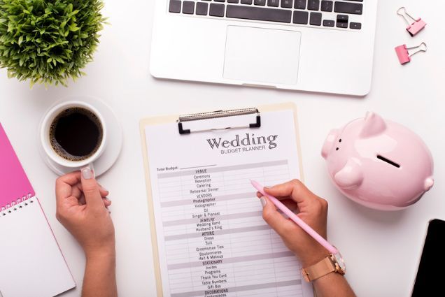 A woman is sitting at a desk planning her wedding.