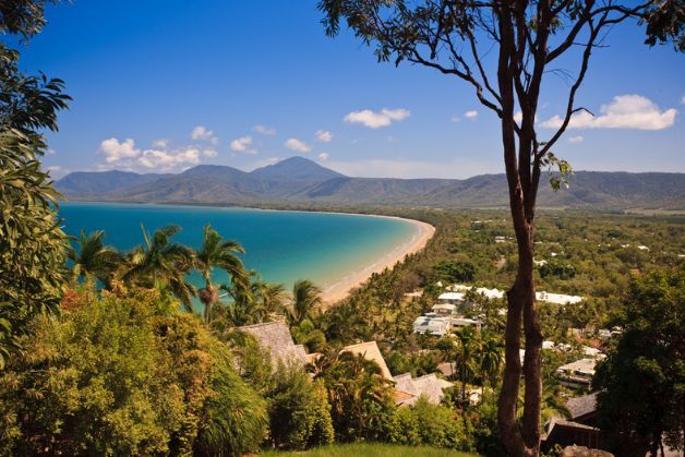 A view of a beach with mountains in the background