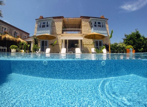 A large house with a swimming pool in front of it