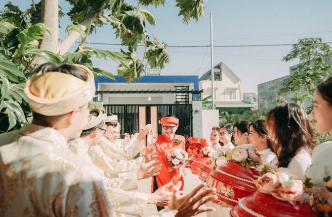 A group of people are standing around a table at a wedding.