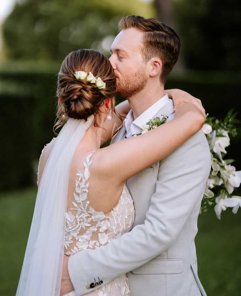 A bride and groom kissing on their wedding day
