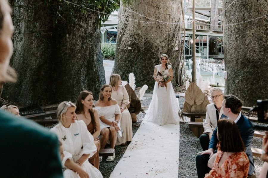 A bride is walking down the aisle at a wedding ceremony.