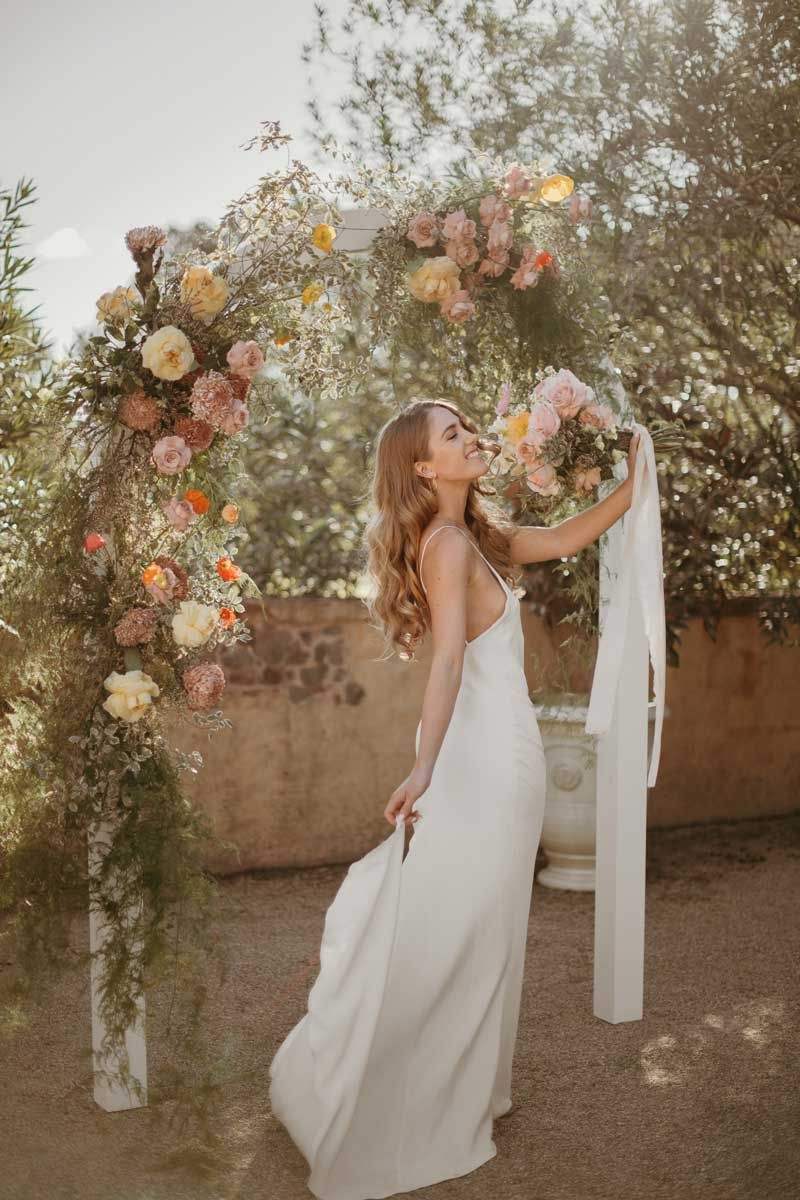 The bride is wearing a white dress and holding a bouquet of flowers.