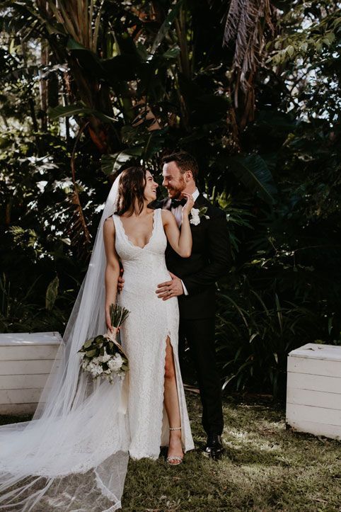 A bride and groom are posing for a picture on their wedding day.
