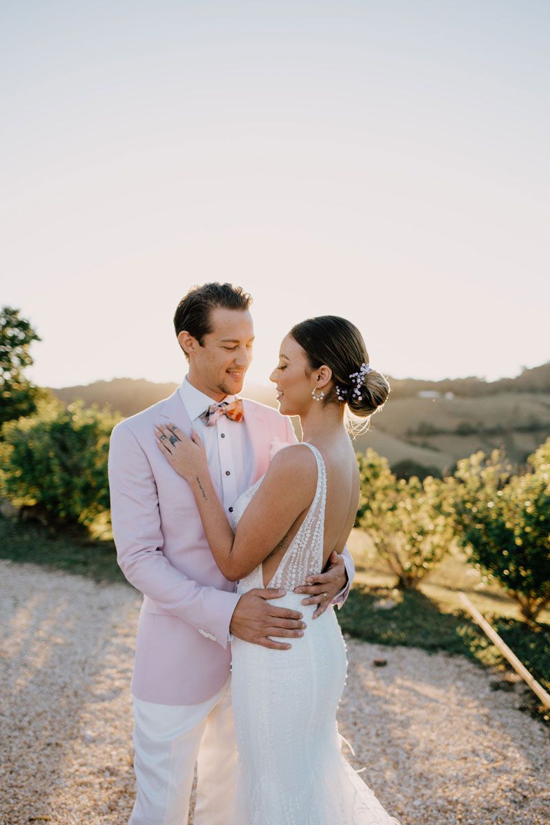 A bride and groom are posing for a picture on their wedding day.