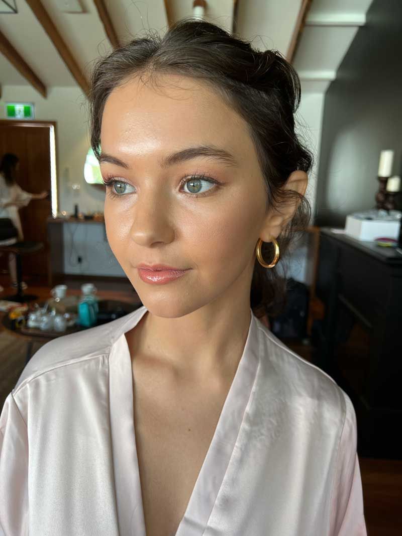 A close up of a woman wearing a robe and hoop earrings.