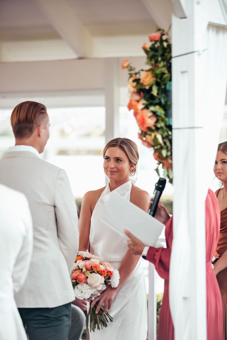 A bride and groom are standing at the altar during their wedding ceremony.