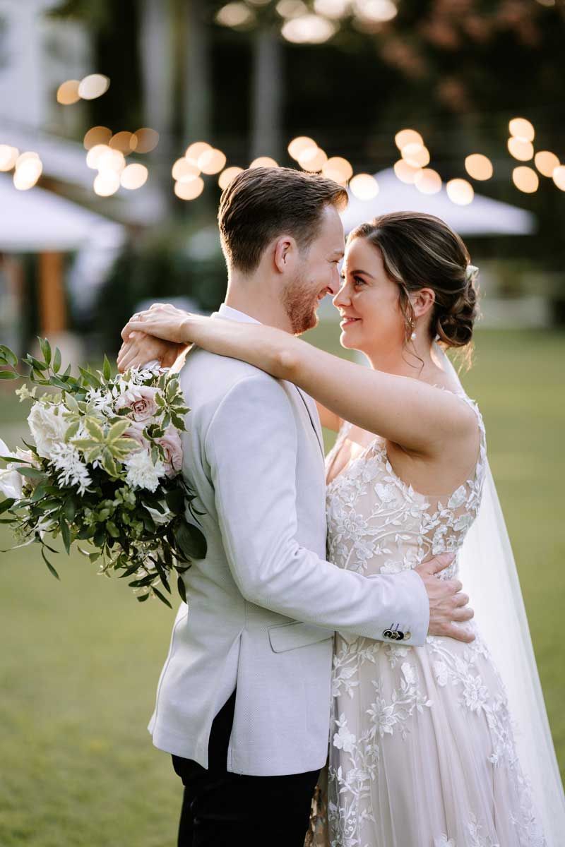 A bride and groom are posing for a picture on their wedding day.