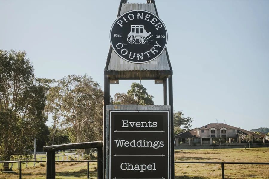 A sign for pioneer country events weddings and chapel