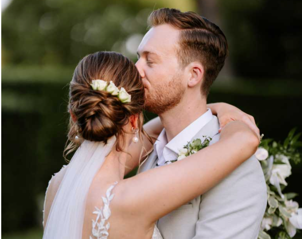 A bride and groom kissing on their wedding day.