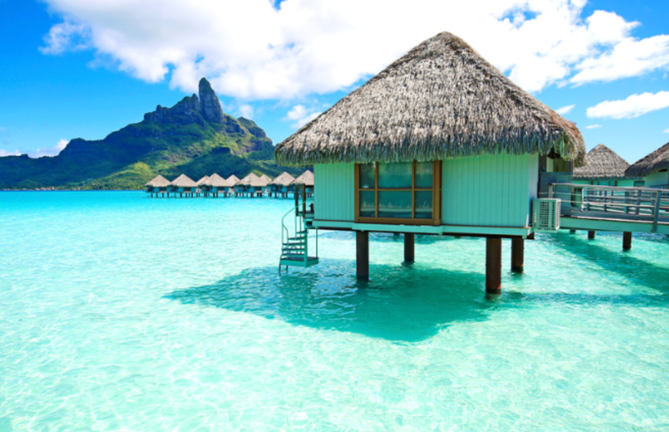 A thatched hut in the middle of the ocean