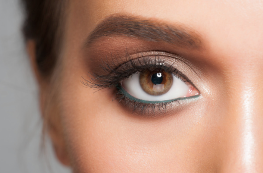 A close up of a woman 's eye with makeup.