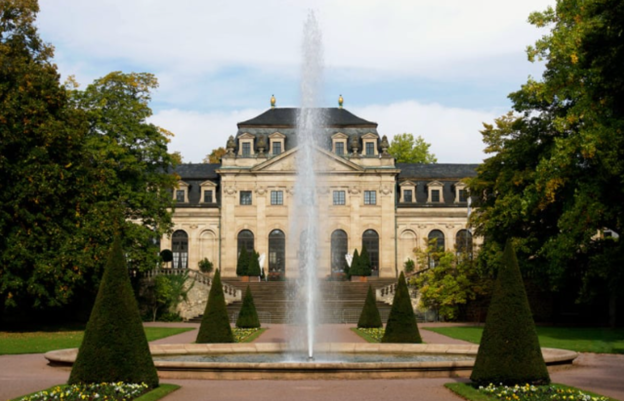 A large building with a fountain in front of it