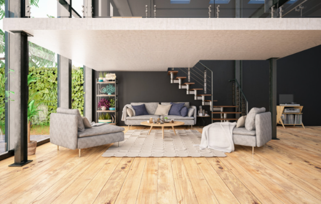 A living room with a couch , chair , coffee table and stairs.