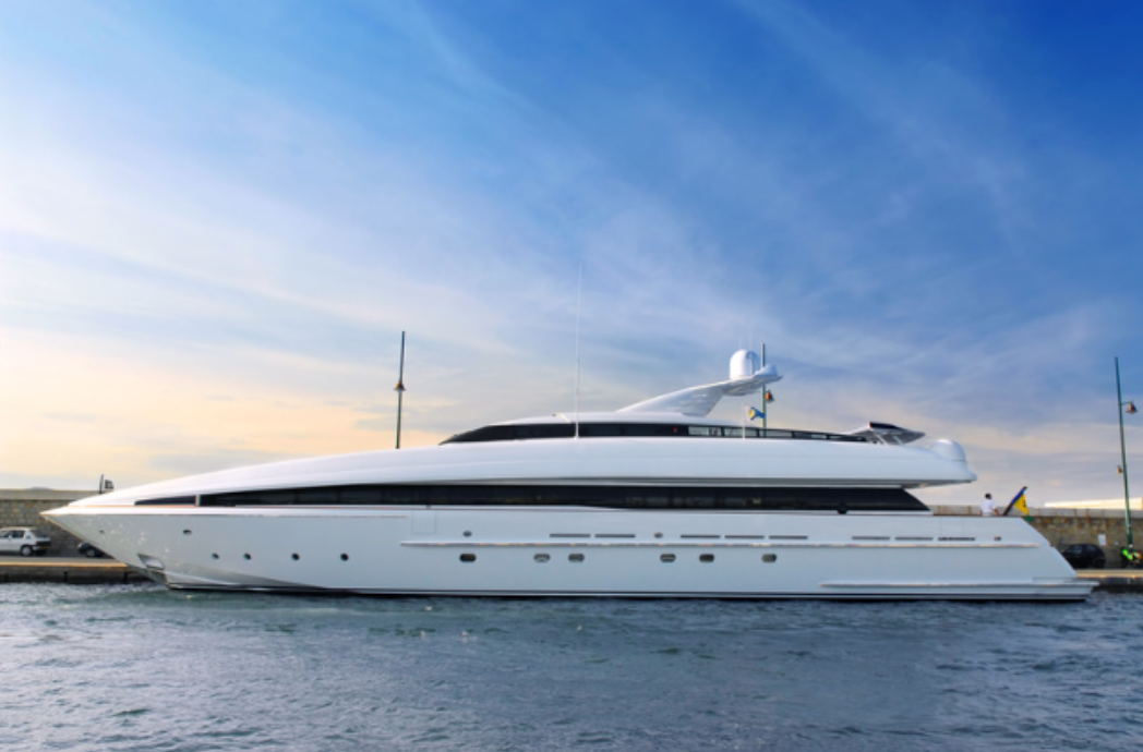 A large white yacht is docked in the water.