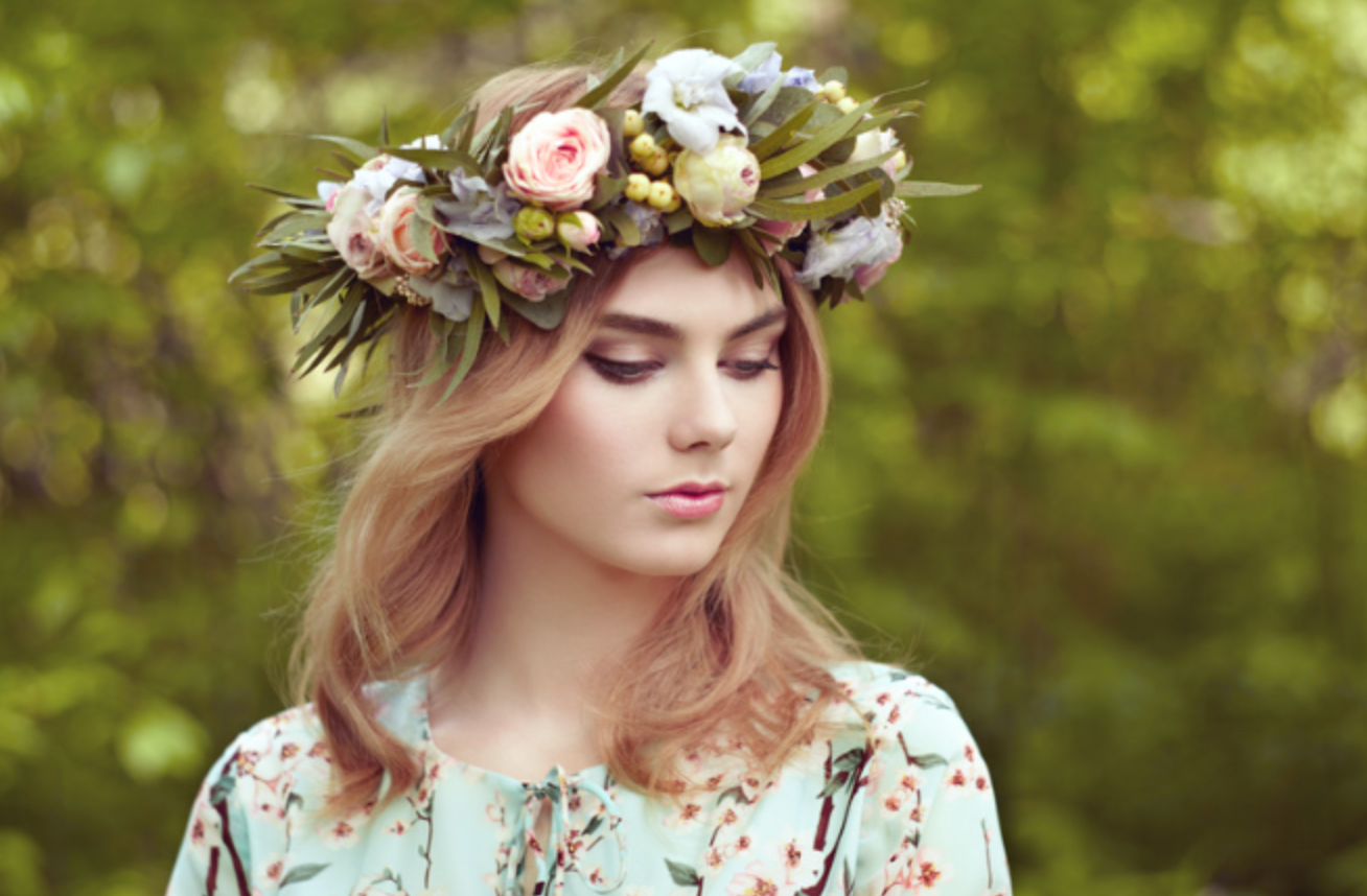 A woman wearing a flower crown on her head.