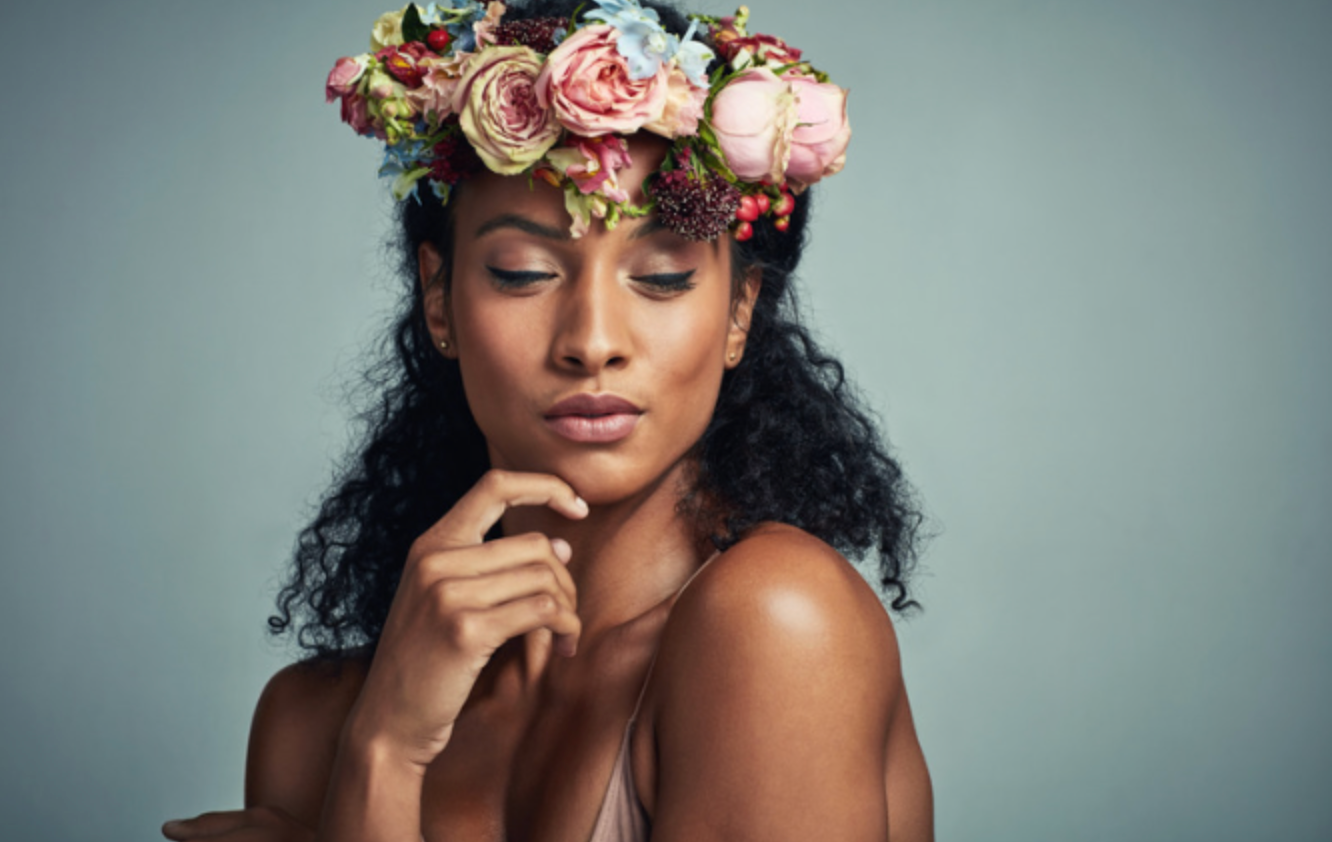 A woman is wearing a flower crown on her head.