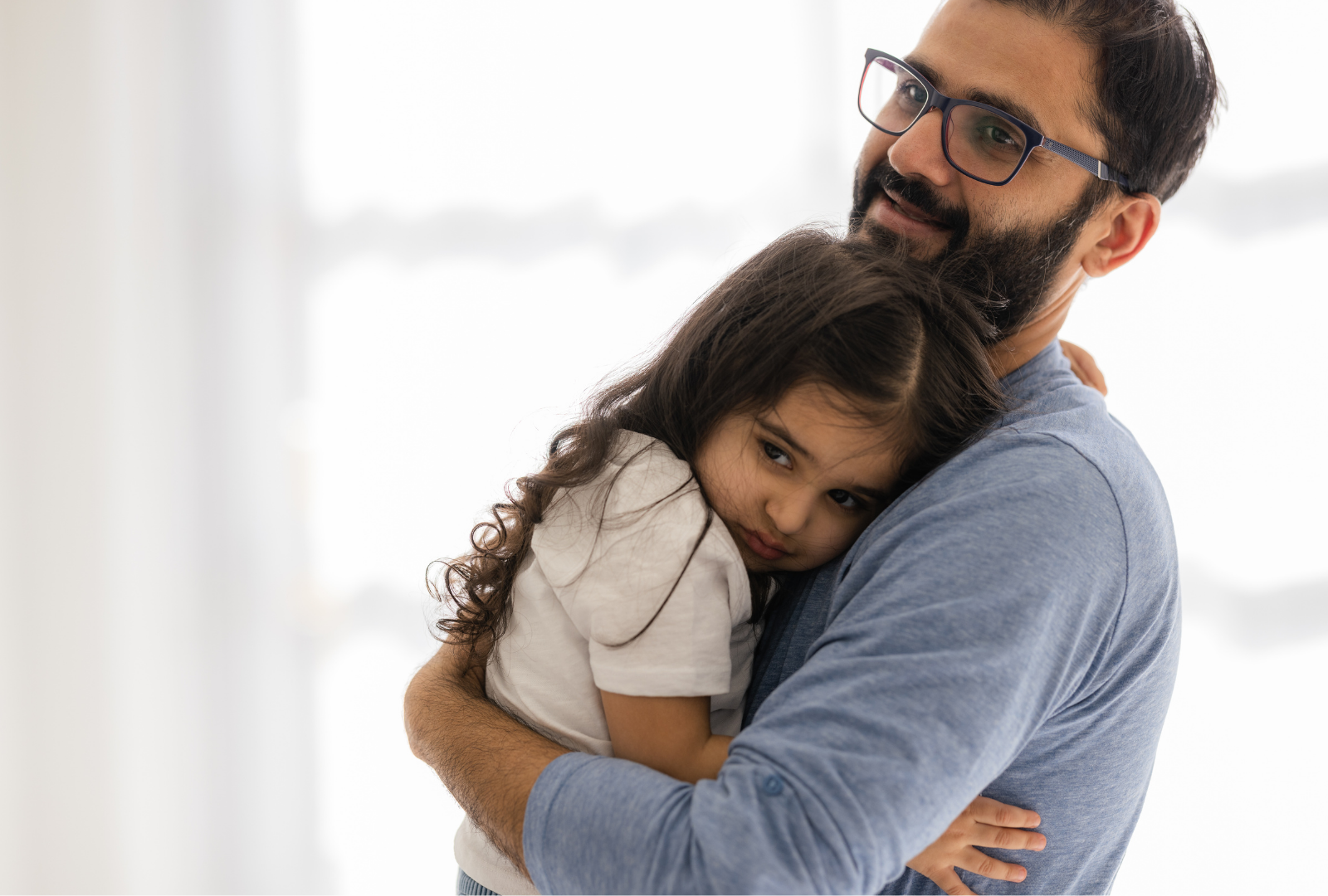 A child with separation anxiety clings to her parent