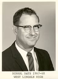 Portrait of a man in glasses and suit with caption “SCHOOL DAYS 1967-68 WEST LINCOLN HIGH.”
