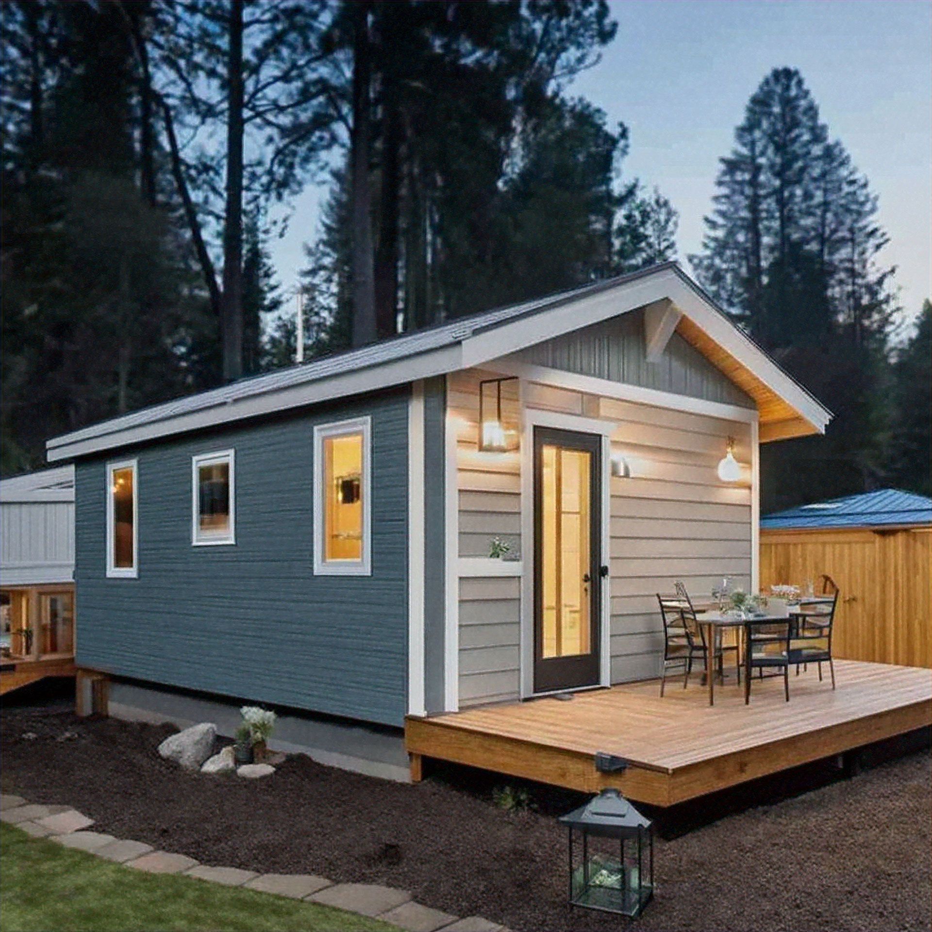 A small house with a wooden deck in front of it