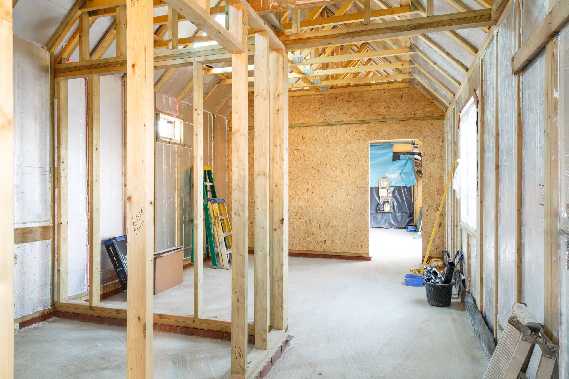 A room in a house under construction with wooden beams
