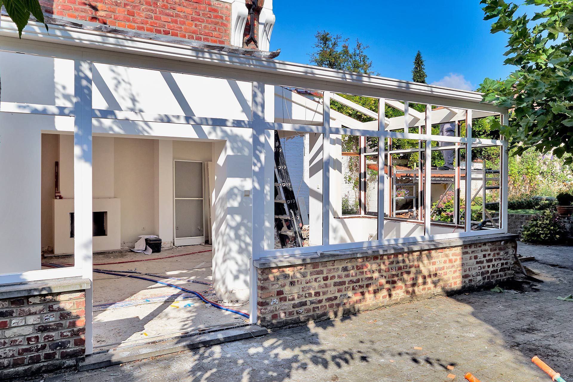 A house is being remodeled with a porch and a brick wall