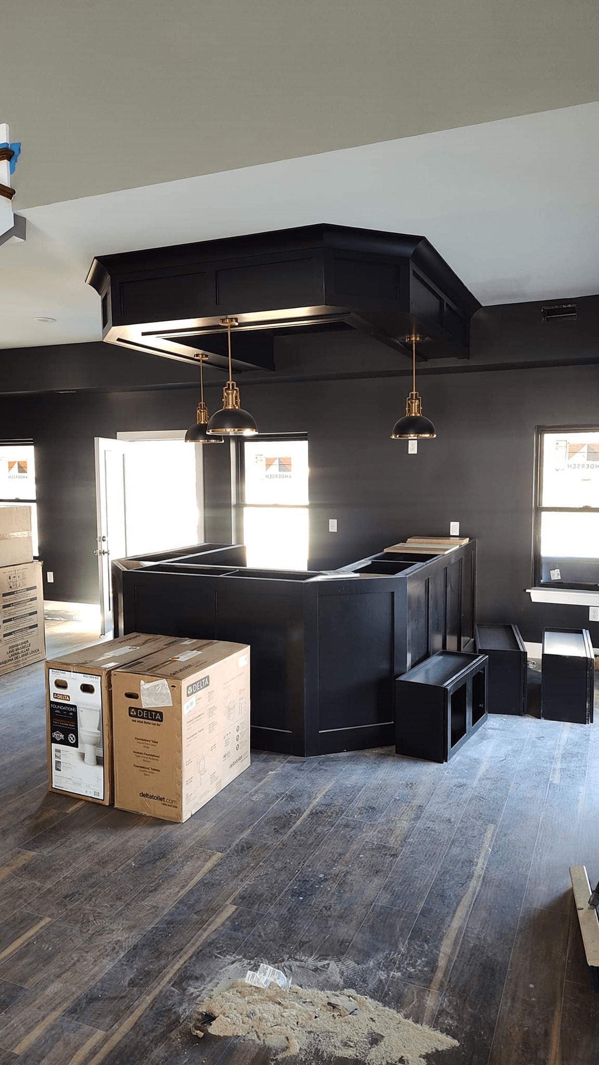 A room with a bar and boxes on the floor
