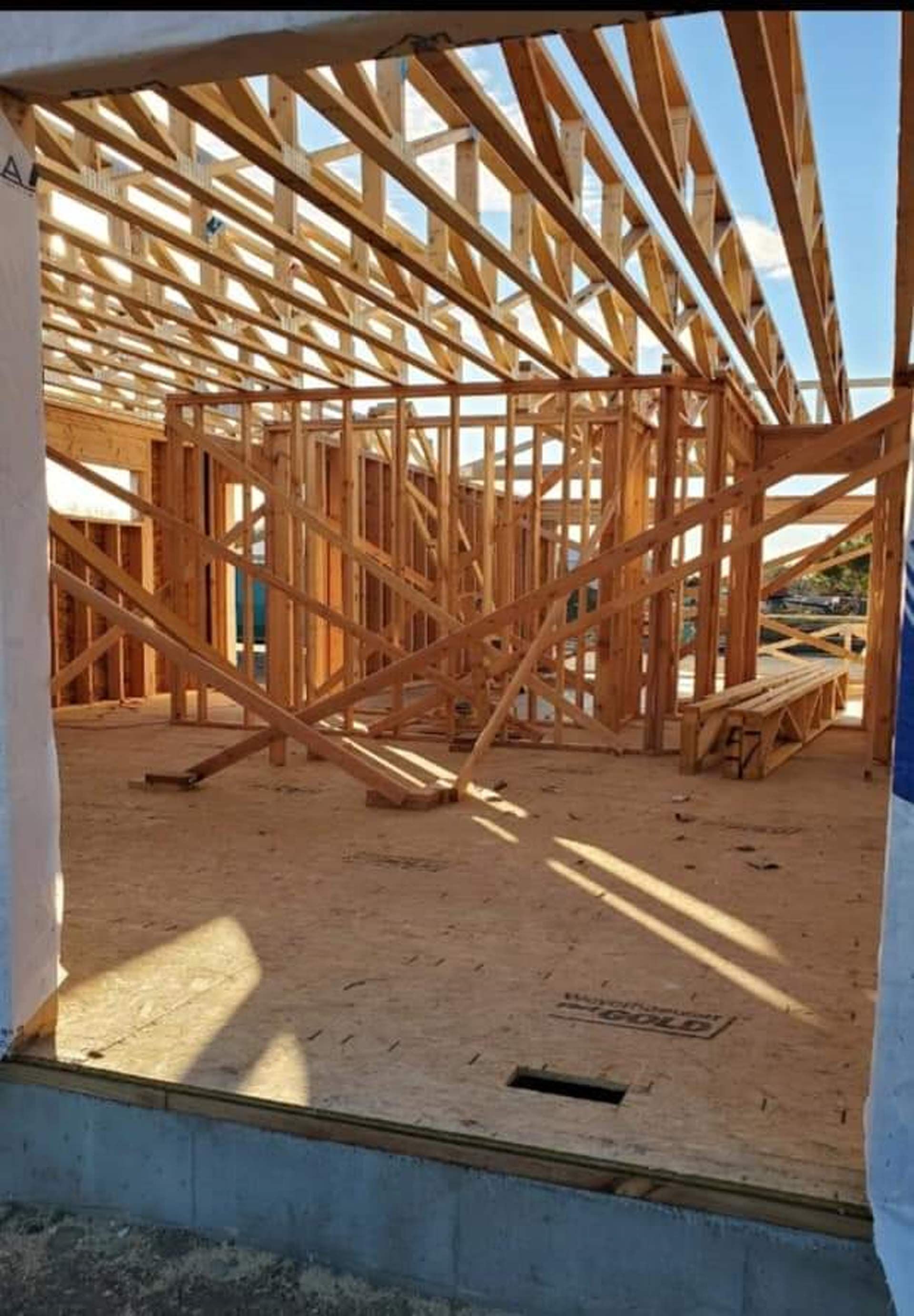 A house is being built with a lot of wooden beams