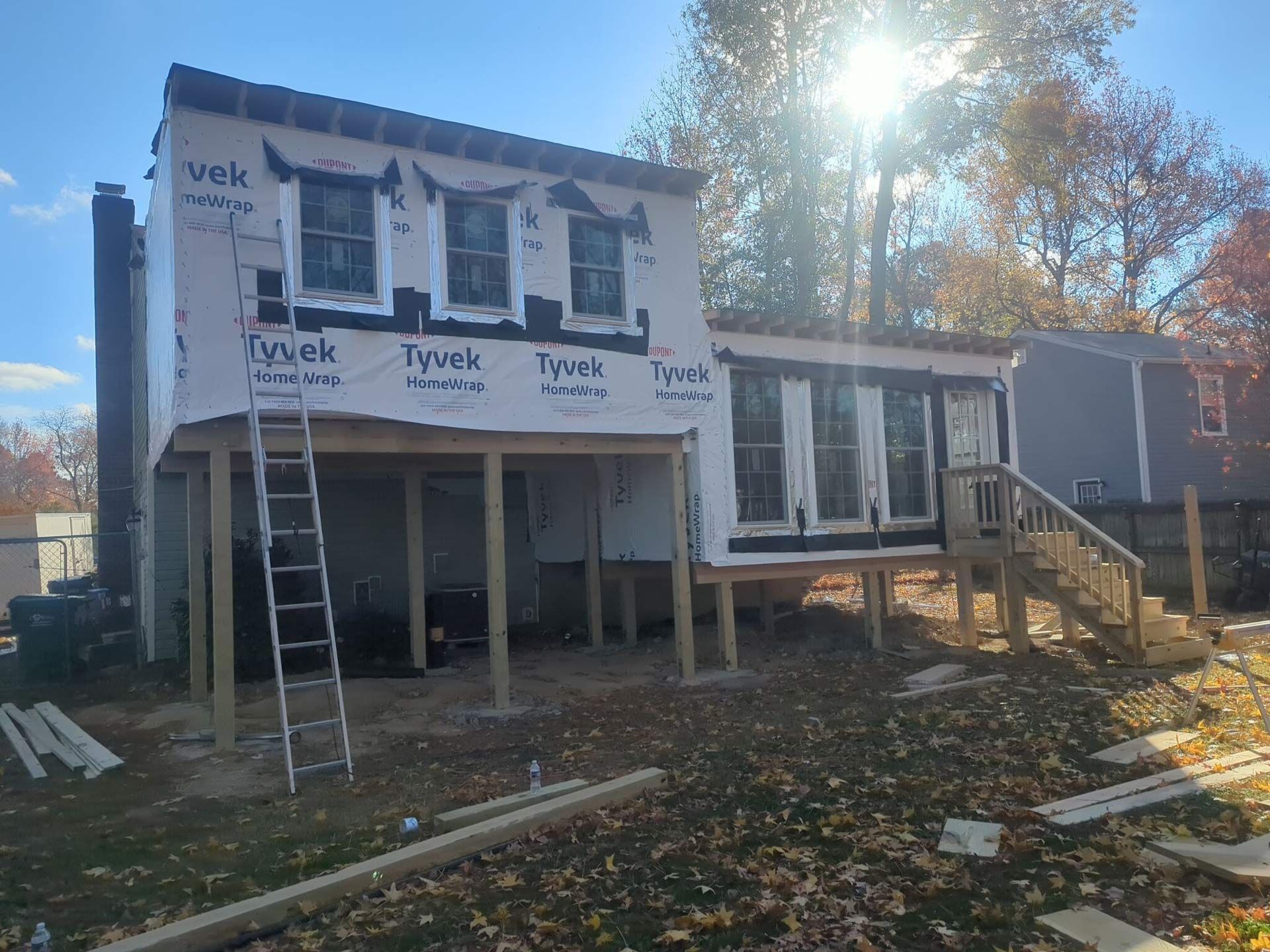 A house under construction with a ladder on the side of it