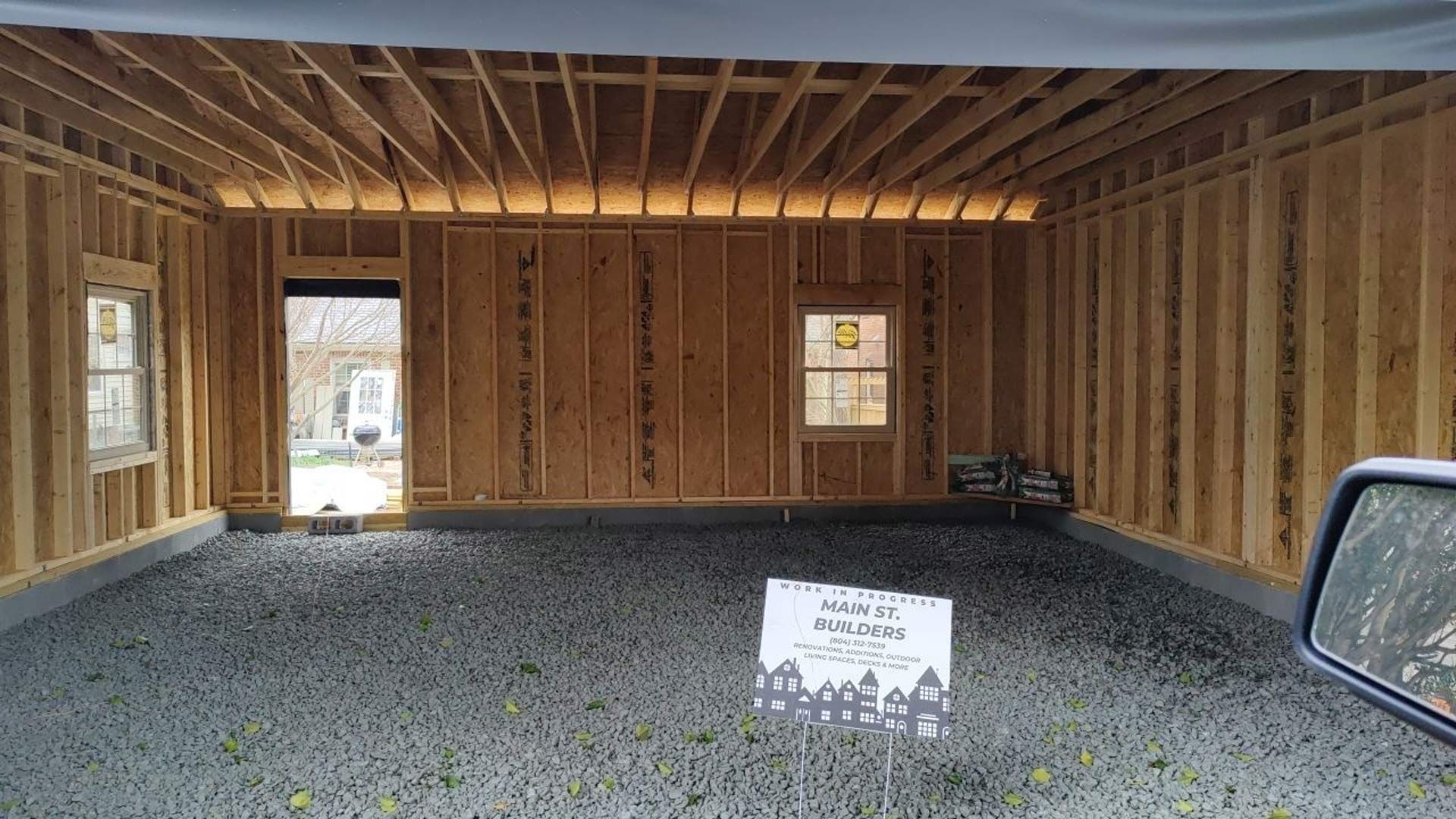 A car is parked in a garage under construction