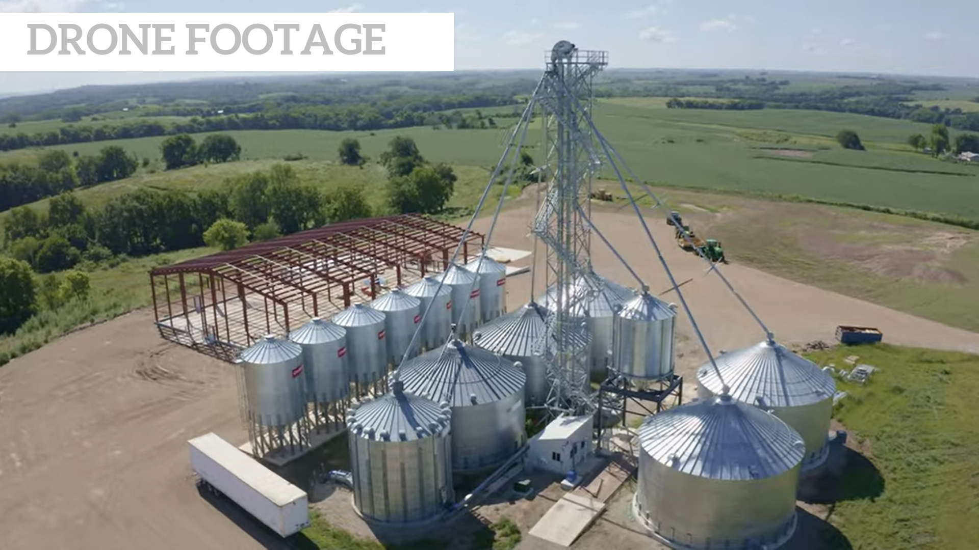 An aerial view of a row of silos in a field.
