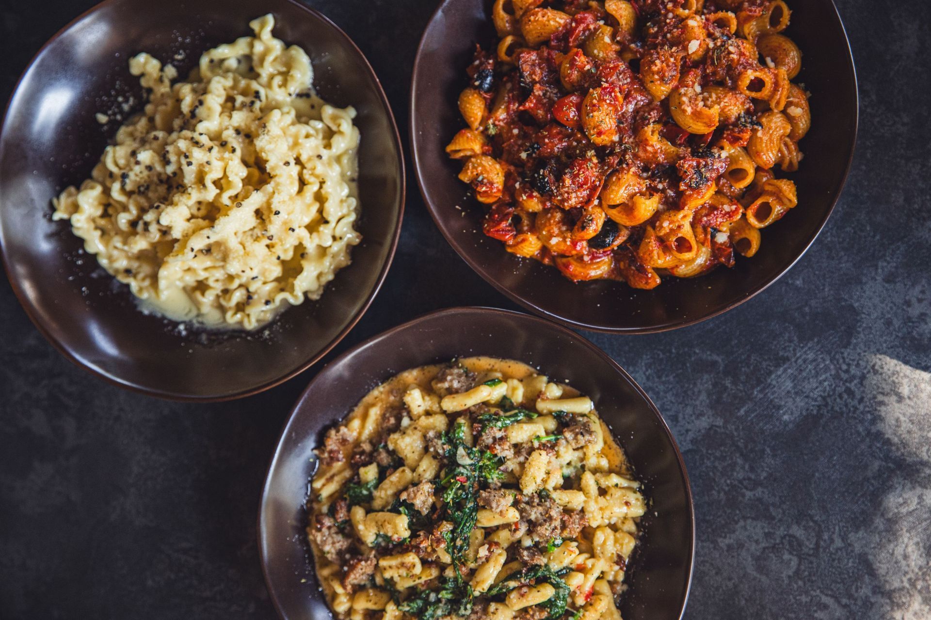 A bowl of mussels is sitting on a table next to a glass of wine.