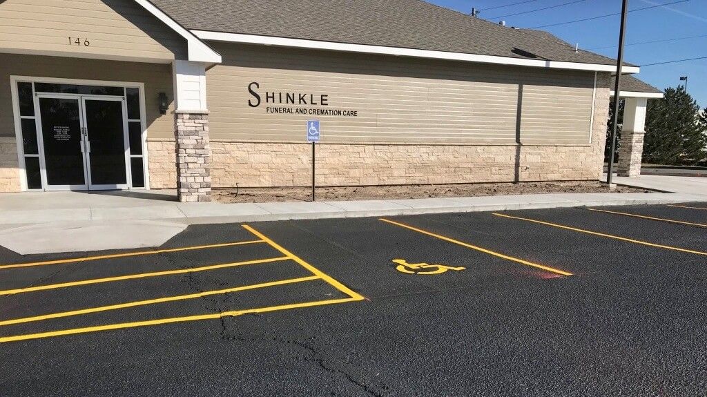A building with a parking lot in front of it.