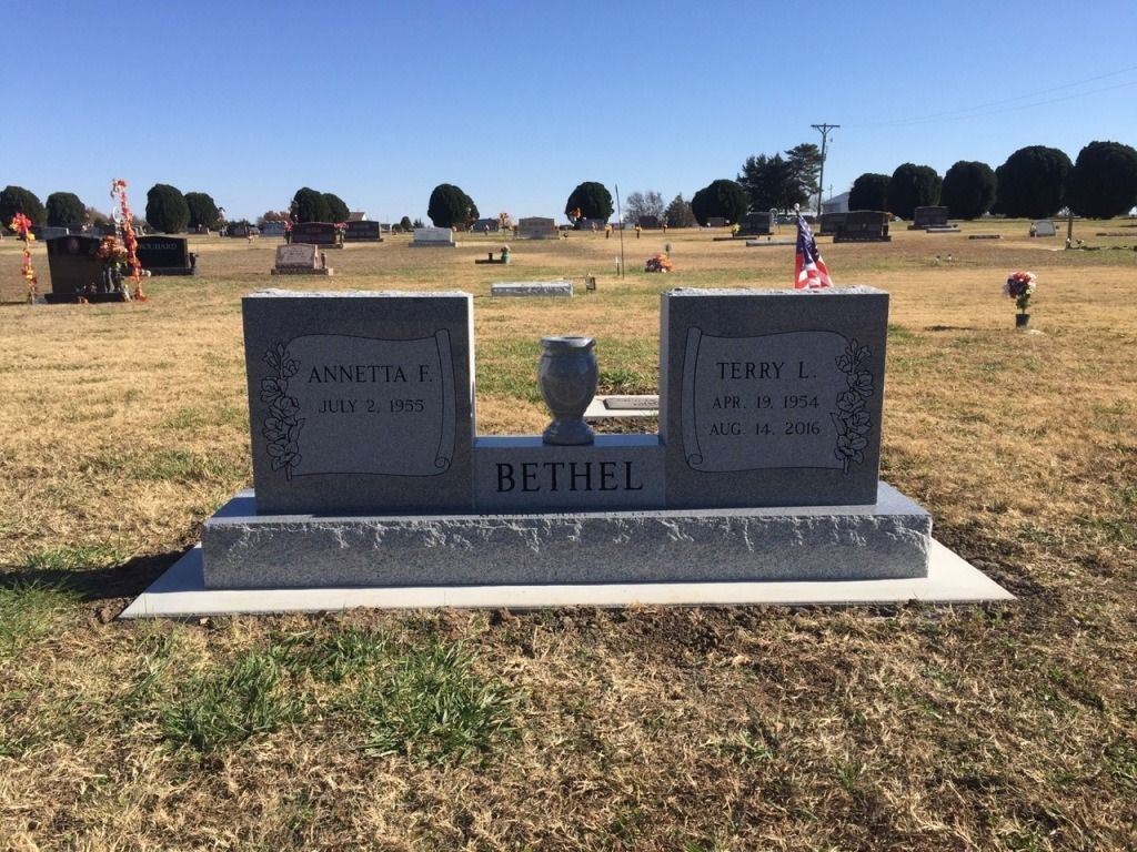 A grave in a cemetery with the name bettici on it