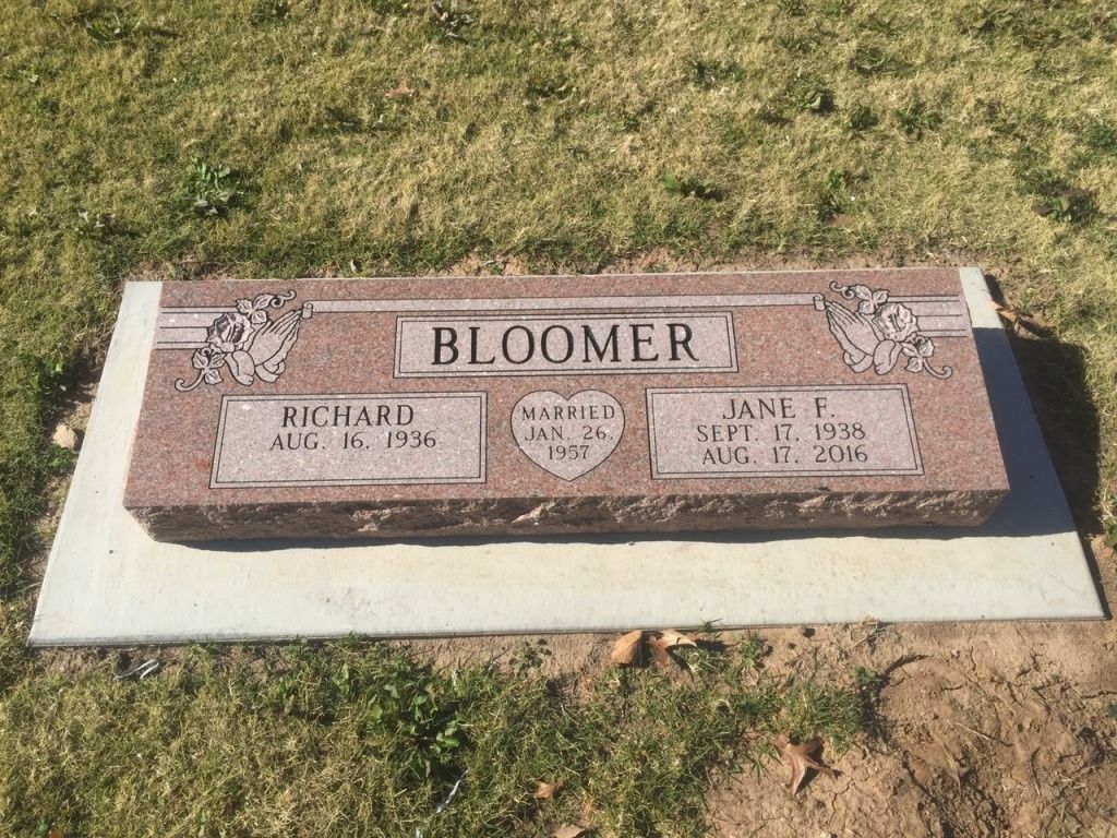 A gravestone in a cemetery with the name bloomer on it.