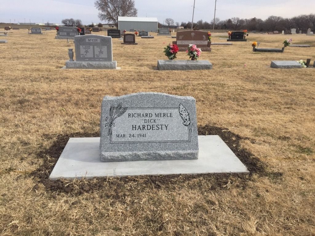 A grave in a cemetery with the name richard on it