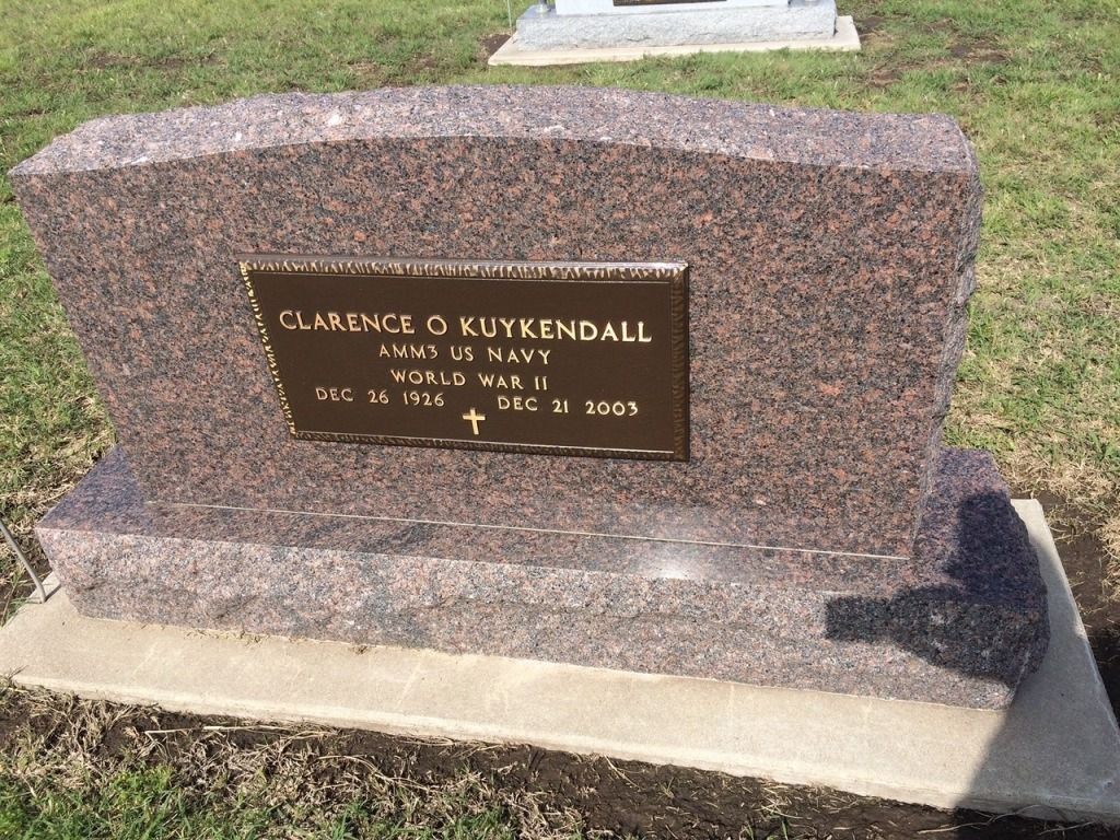 A gravestone in a cemetery with the name clarence on it